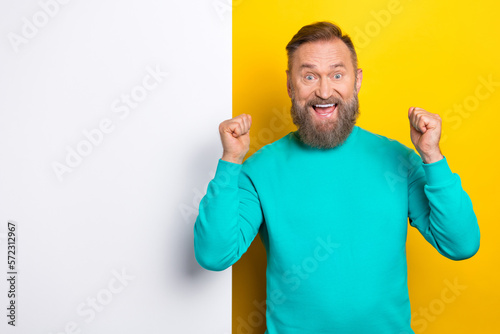Photo of overjoyed man wear stylish clothes hand fist rejoice seasonal sale special deal empty space isolated on yellow color background