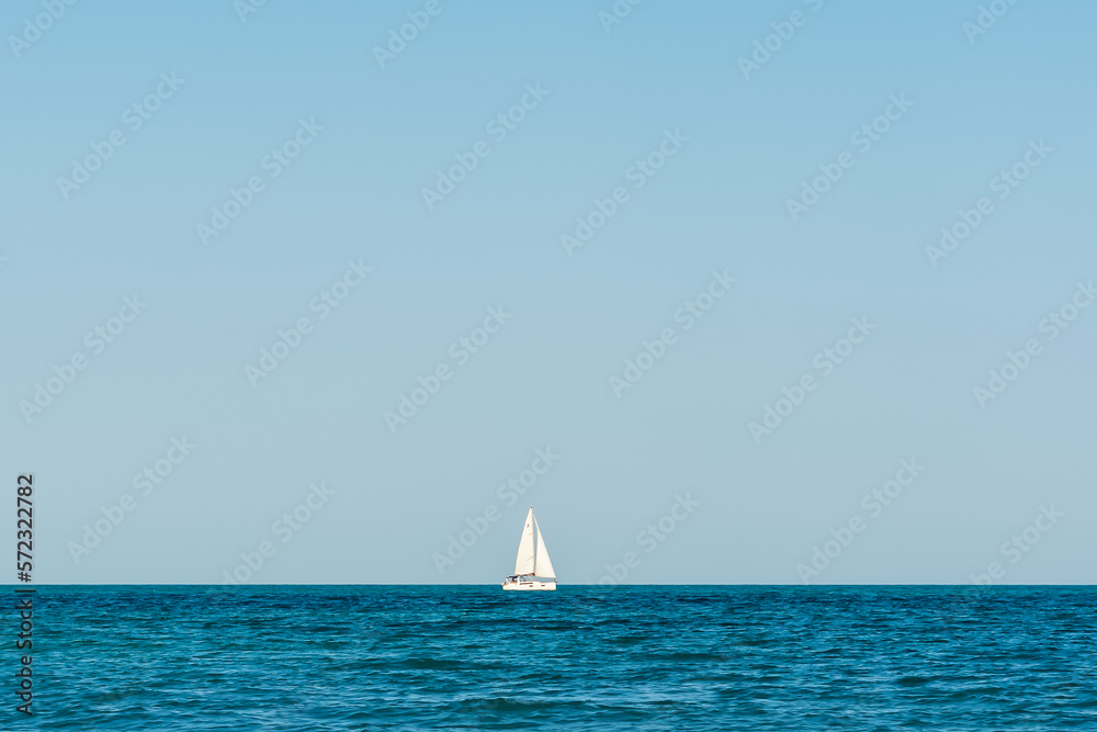 Obraz premium single white boat on the black sea