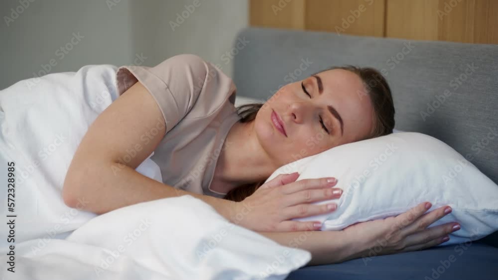 Beautiful young woman sleeping while lying in bed comfortable and blissfully. Young beautiful woman sleeping in her bed and relaxing in the morning. Beautiful young woman sleeping while lying in bed comfortable and blissfully. Young beautiful woman sleeping in her bed and relaxing in the morning.