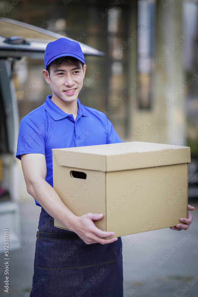 Deliver service. Man With Box in Car Outdoors Delivery Man in uniform holds parcel and phone car outdoors Delivery man taking parcels from The Delivery service. Deliver service. Man With Box in Car Outdoors Delivery Man in uniform holds parcel and phone car outdoors Delivery man taking parcels from The Delivery service.
