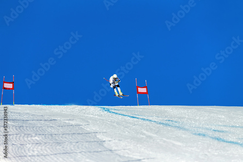 alpine skiing race. athlete skiing between red gates photo