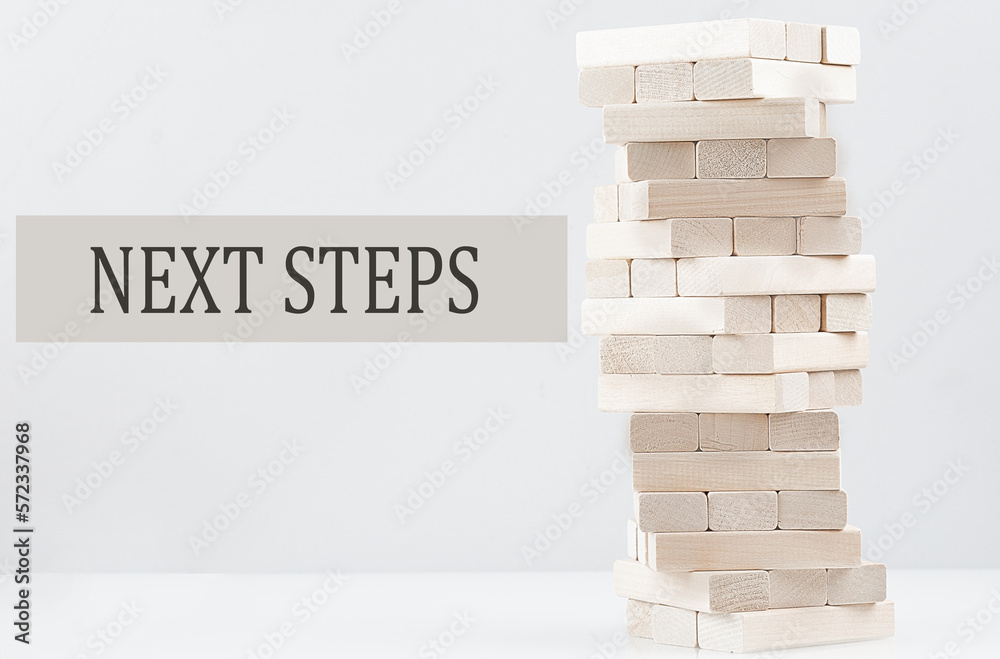 NEXT STEPS text with wooden block stack on white background , business ...