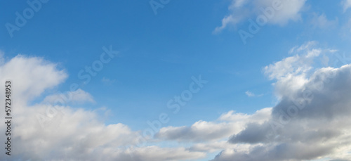 White clouds in the blue sky in sunny weather