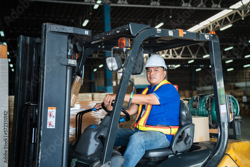 Warehouse worker workers with forklift in a warehouse. Use forklift operator moves packages. Concept industrial and commercial.