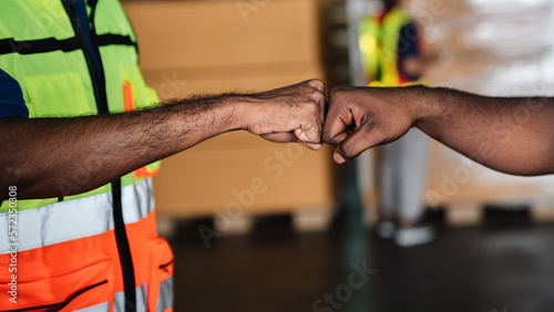 Group warehouse workers shake hands to celebrate and be happy in the warehouse., Industrial and industrial concept.