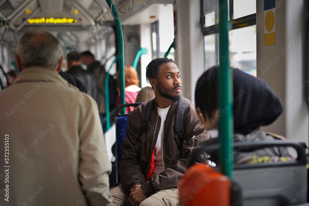 portrait of young man in a tram - obrazy, fototapety, plakaty 