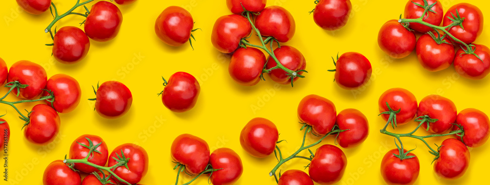 Tomato on a branch sprout top view flatlay on a yellow background. Fresh juicy ripe tomato Red Cherry fruits. Salad preparation ingredients Tomato on a branch sprout top view flatlay on a yellow background. Fresh juicy ripe tomato Red Cherry fruits. Salad preparation ingredients