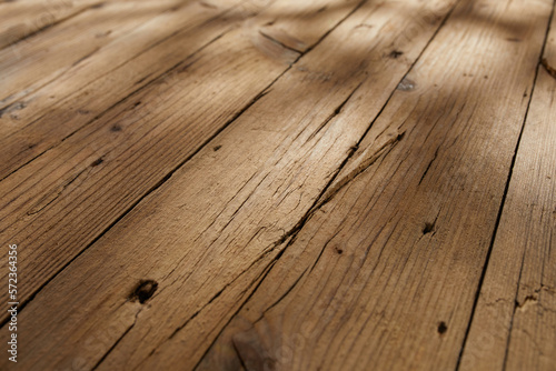 texture of old wooden surface with cracks. background from brown boards. top of an old table with sun spots. empty table top