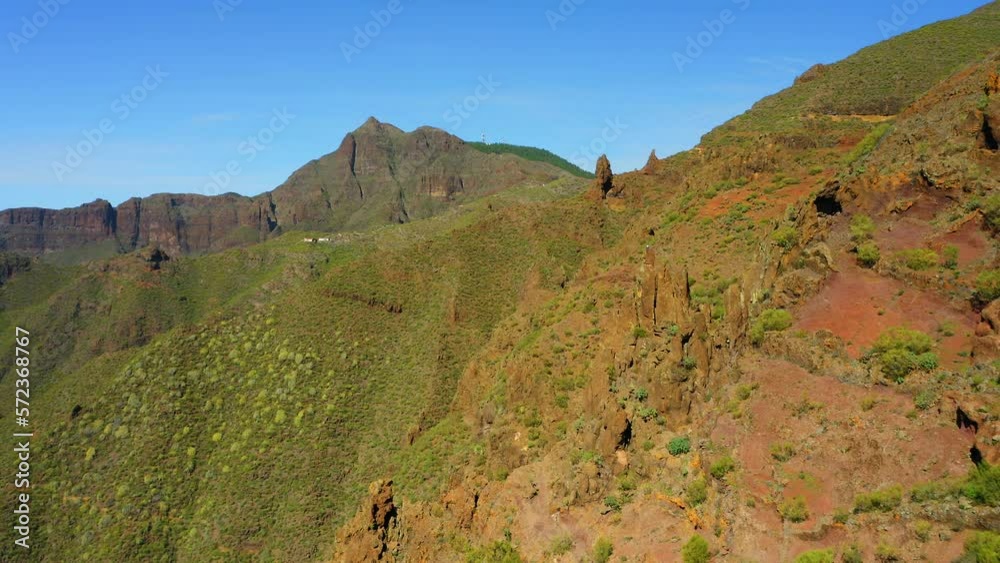 High volcanic green mountains form a huge gorge in Teno national park Masca village. Hiking area. Tourist attraction. Aerial cinematic flight. Tenerife Canary Islands Spain Europe.