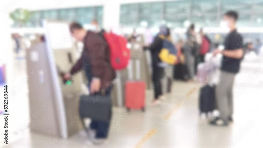 Abstract blur and defocussed passengers using self service machines for check-in at airport terminal Abstract blur and defocussed passengers using self service machines for check-in at airport terminal
