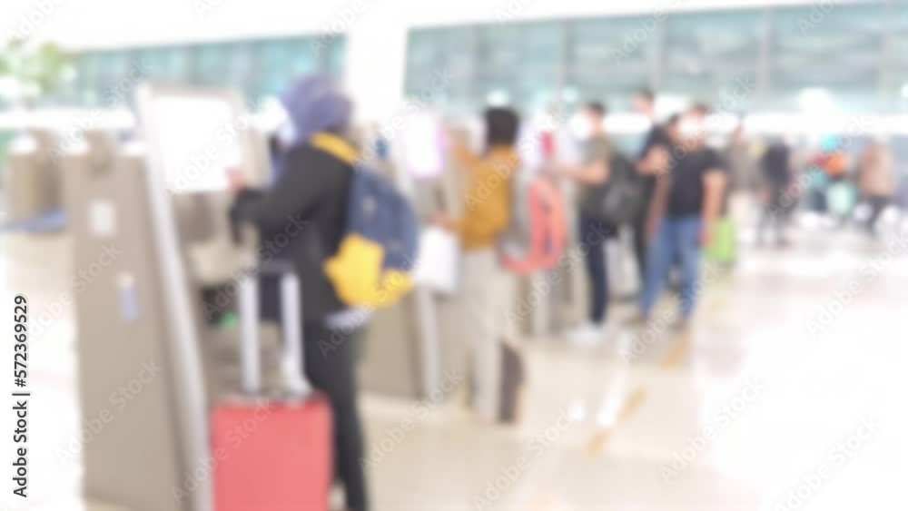 Abstract blur and defocussed passengers using self service machines for check-in at airport terminal Abstract blur and defocussed passengers using self service machines for check-in at airport terminal