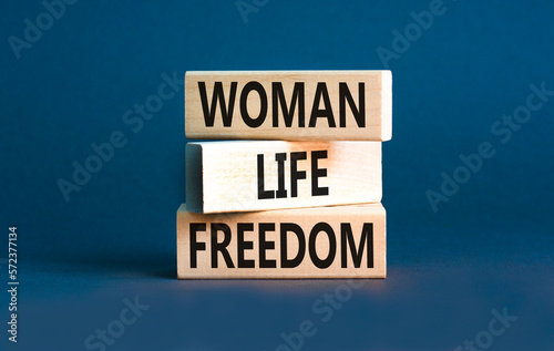 Woman life freedom symbol. Concept words Woman Life Freedom on wooden blocks on a beautiful grey table grey background. Social issue woman life freedom concept. Copy space. © Dzmitry