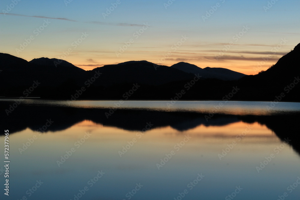 Stunning blue hour, twilight or dusk reflection over the Meeting of the Waters in Killarney National Park in winter. Close up view from popular stone lookout point on Ring of Kerry