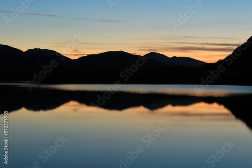 Stunning blue hour, twilight or dusk reflection over the Meeting of the Waters in Killarney National Park in winter. Close up view from popular stone lookout point on Ring of Kerry © Aldercy Carling