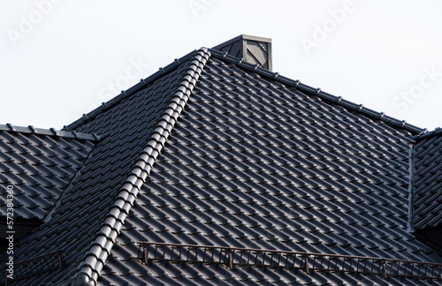 A tile roof on a new house. Modern roof made of metal. Modern house construction