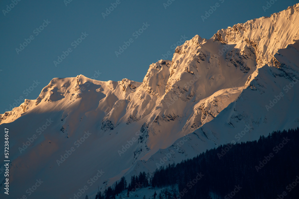 beautiful sunrise and view of the hohe  tauern in the national park in austria at a winter morning
