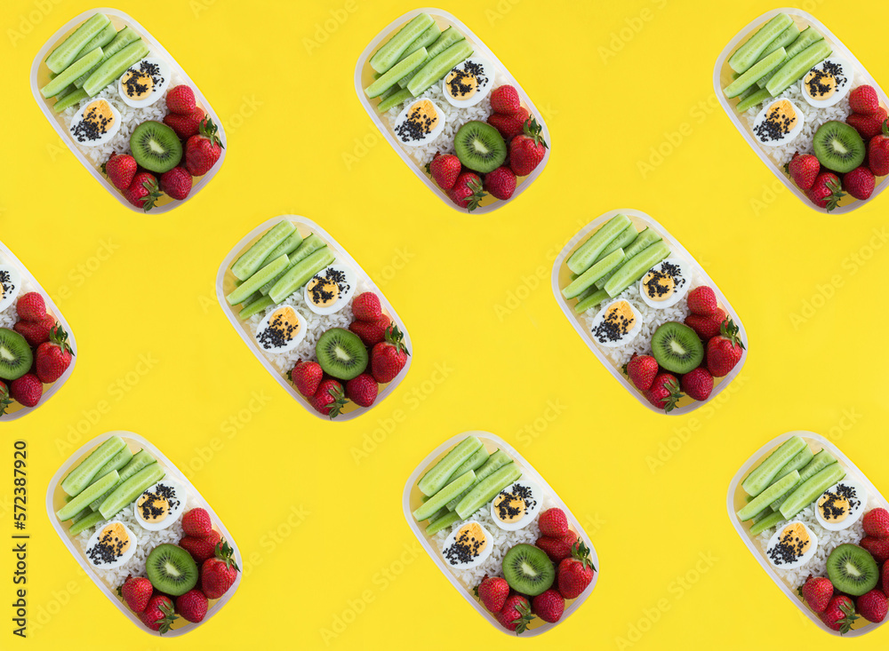 Top view of lunch box on the yellow background. Pattern. Flat lay.
