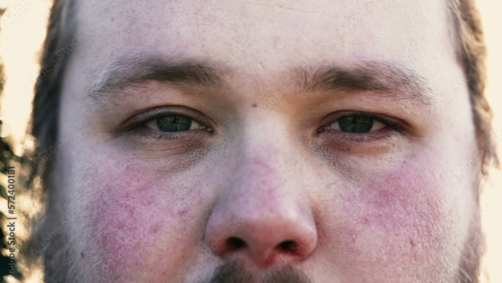 Young man macro eyes close up looking at camera Young man macro eyes close up looking at camera