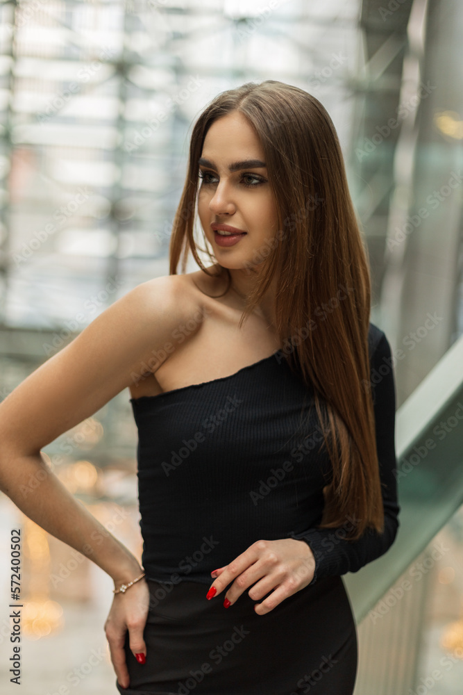Beautiful business lady in fashionable black clothes in an office building