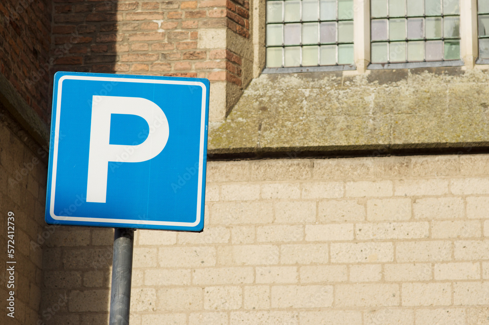 Blue parking sign with a building in the background in the Netherlands Blue parking sign with a building in the background in the Netherlands