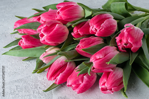 bouquet of pink tulips on a concrete background