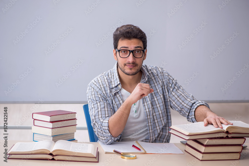 Young male student sitting in the classroom Young male student sitting in the classroom