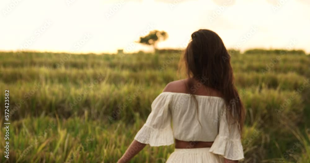Carefree woman wearing straw hat in the rice field Carefree woman wearing straw hat in the rice field