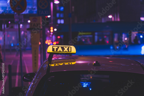 illuminated taxi sign in the city at night