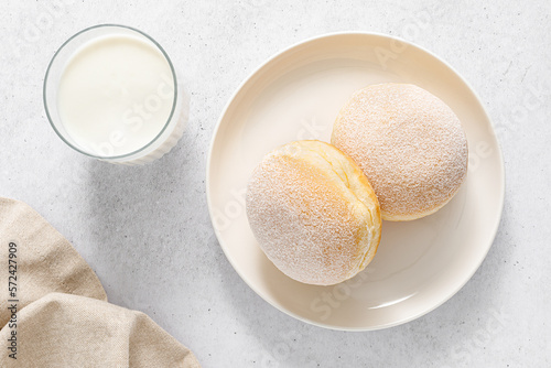 Berliner donut. Traditional german donut with raspberry jam, dusted with icing sugar. Top view