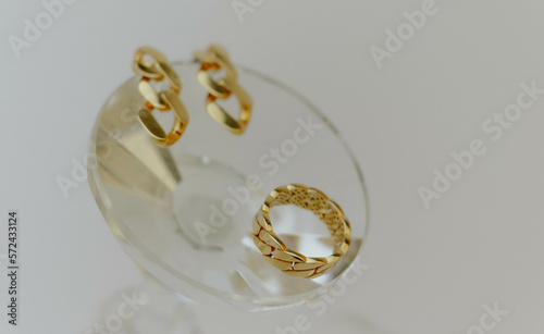 Golden earrings with ring in the box