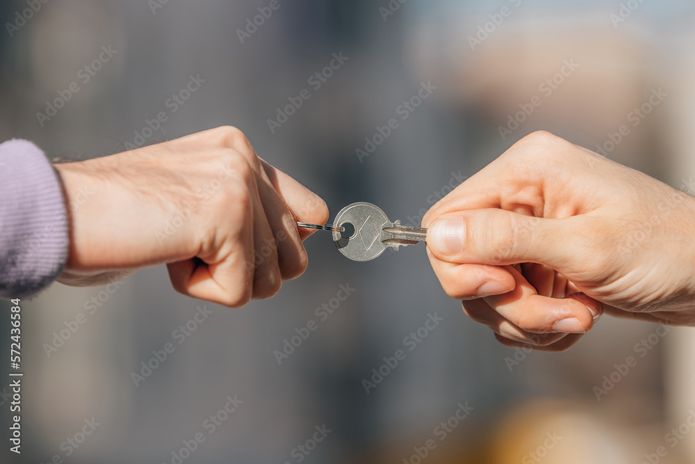 close-up of hands disputing the key to the apartment or rent