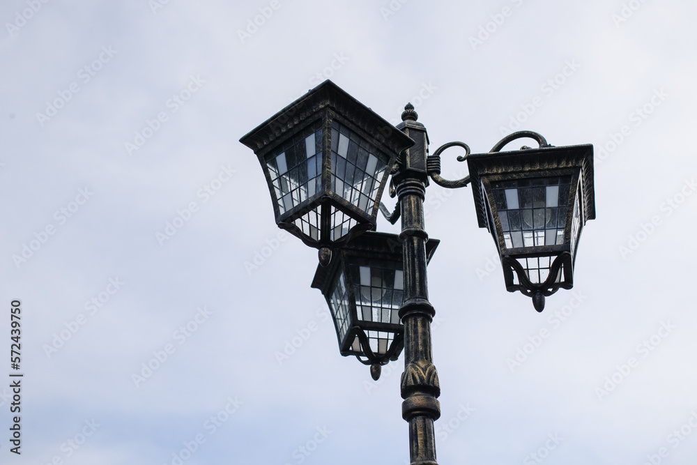 Metal street lamp on the background of the sky