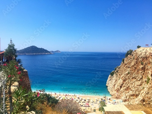 Kaputaj beach in Turkey Antalya region Kalkan Kas, sea view tourists with beach umbrellas photo