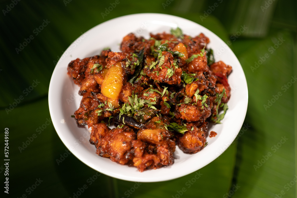 A serving of a vegetarian dish made from fried cauliflower. Known as 'gobi 65', it is based on the 'gobi chicken' recipe originating from southern India. A serving of a vegetarian dish made from fried cauliflower. Known as 'gobi 65', it is based on the 'gobi chicken' recipe originating from southern India.