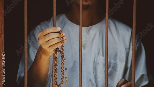 Religious muslim islam man in white session lift hand for praying and wearing bead on hand to determine the number of prayer services.concept for Ramadan,Eid al Fitr, eid ad-ha, meditation, praying