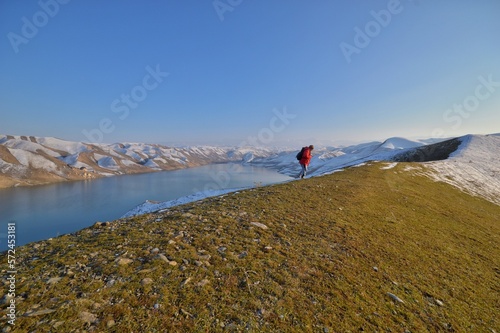 hiking in the mountains Man in red jacket traveler in Pamir mountains Asia 