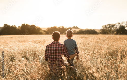 Father and son out in a field enjoying nature 