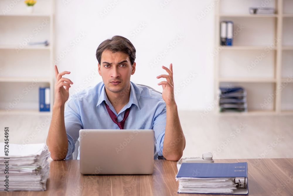 Young male employee working in the office Young male employee working in the office
