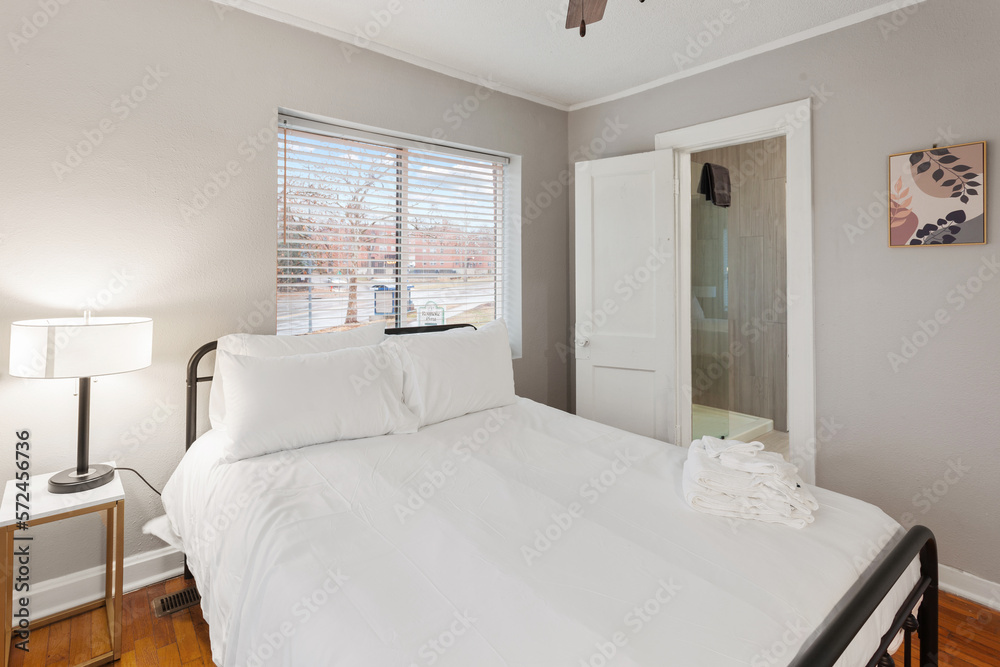 Fototapeta premium White apartment with wide open spaces, hardwood flooring and modern furniture. Used as a short term rental. 