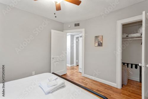 White apartment with wide open spaces, hardwood flooring and modern furniture. Used as a short term rental. 