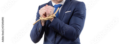 man in a suit with hands tied is trying to free himself. concept of financial dependence and slavery. Copy space