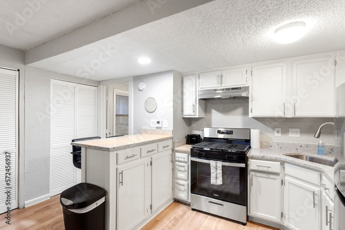 Modern Efficiency: Short-Term Rental with White Cabinets, Wood Floors, and Open Floor Plan