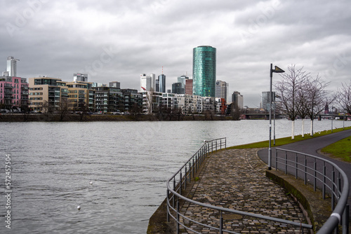 View across the Main river in Frankfurt to the Westhafen Tower on a cloudy sky photo