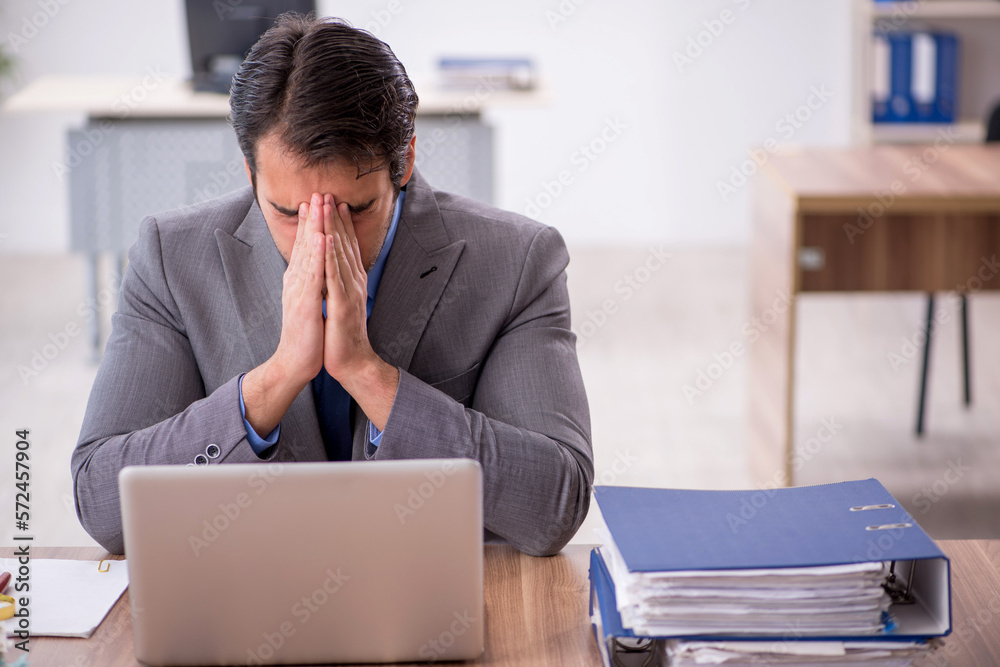 Young male employee working in the office Young male employee working in the office