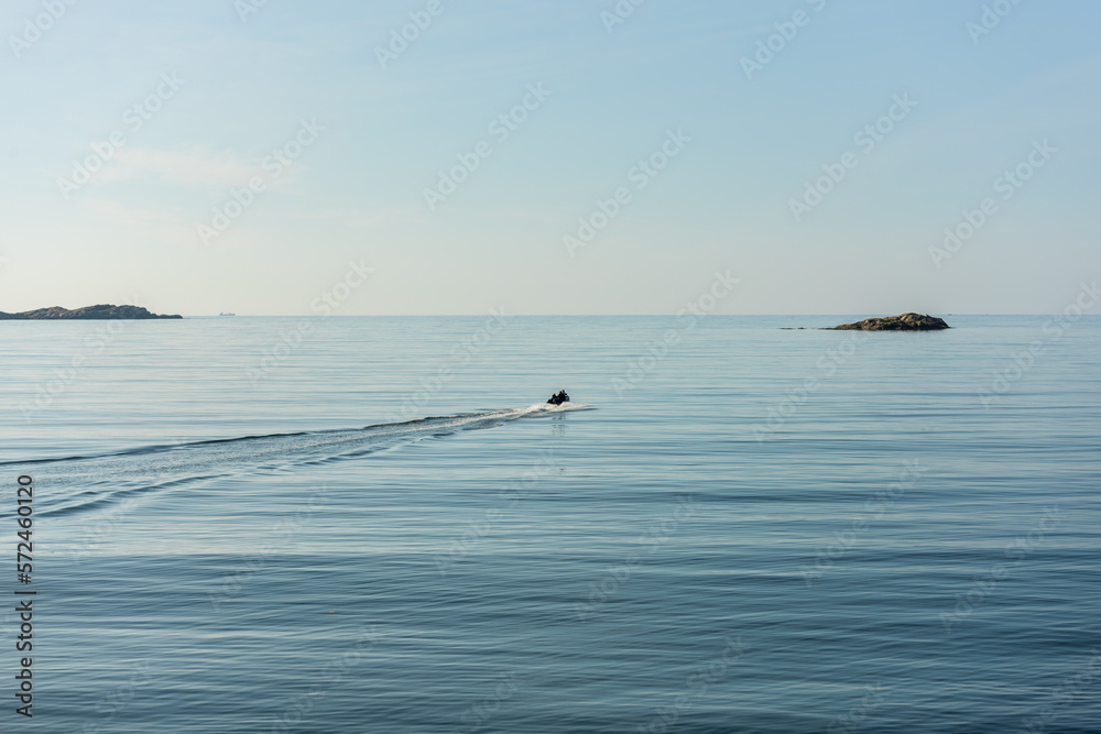 Small boat setting out to sea on a quiet and sunny morning. Small boat setting out to sea on a quiet and sunny morning.