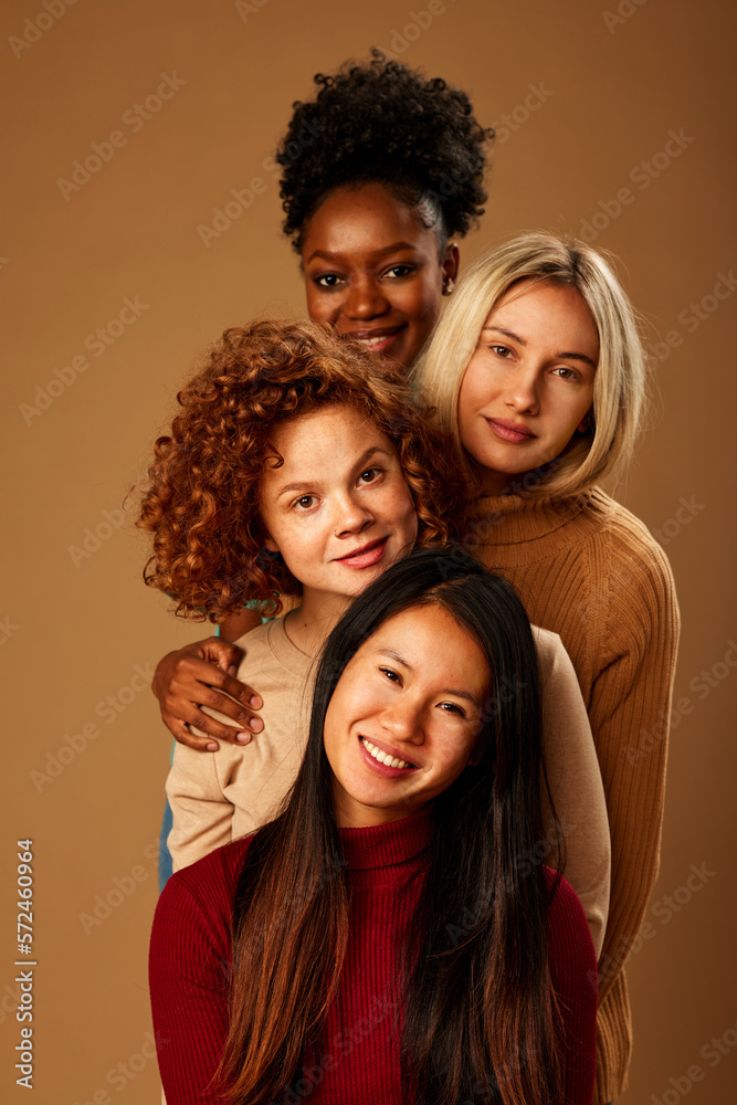Four pretty multicultural girls with natural skin posing and smiling at the camera. Four pretty multicultural girls with natural skin posing and smiling at the camera.