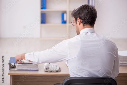 Young male employee working in the office