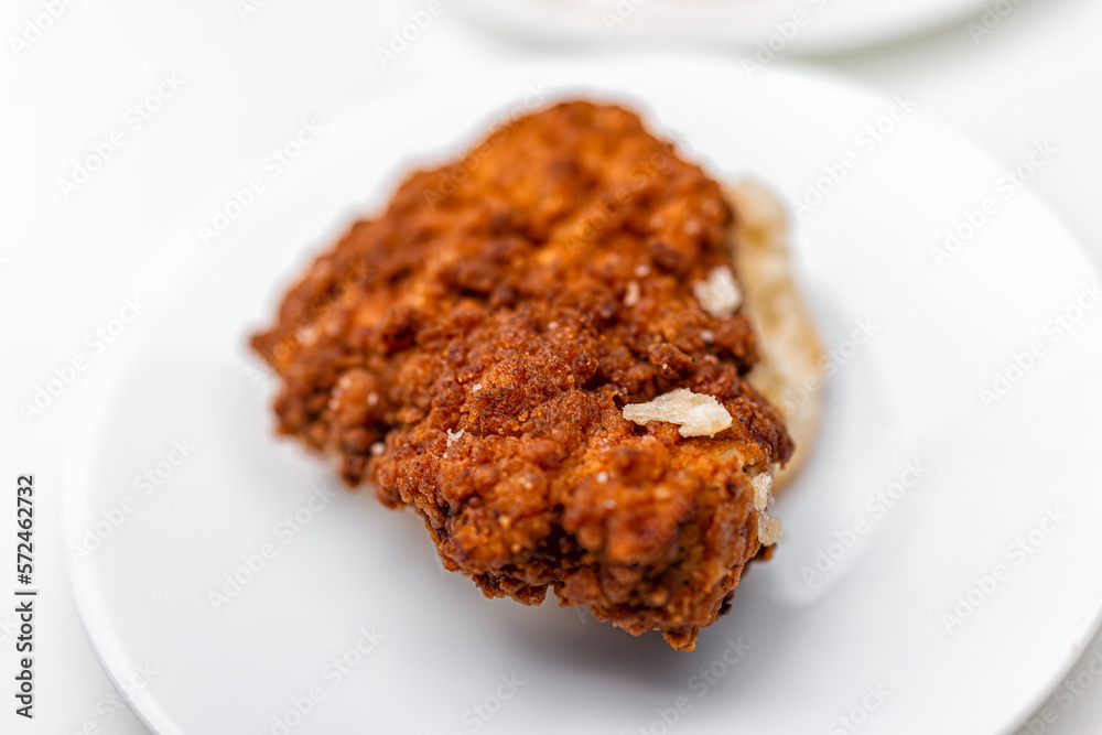 Chicken sandwich deep fried crispy meat on breakfast biscuit buns bread, fresh fast food on white plate at kitchen table plate macro closeup flat top view