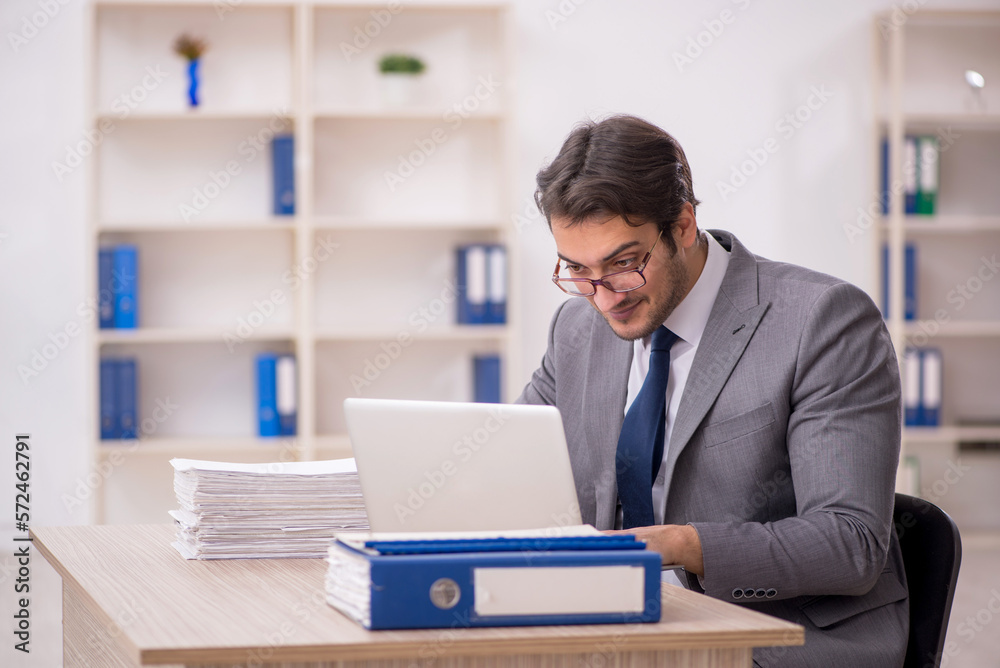 Young male employee working in the office Young male employee working in the office
