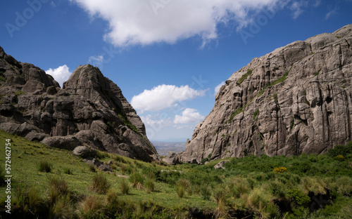 Alpine landscape. Panoramic view of the rocky hills, valley and grassland. 